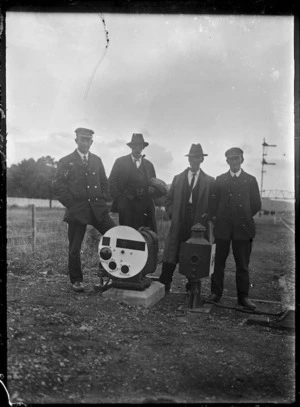 Four men standing behind a three position ground signal at Trentham.