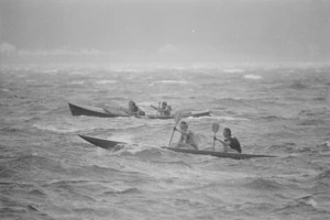 Surf lifesavers paddling boats in choppy waters