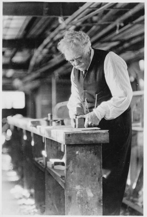George Norton working at his bench in the Star Boating Club, Wellington