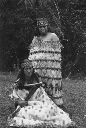 Two women, including Rangihikatea Maihi, wearing fine flax cloaks