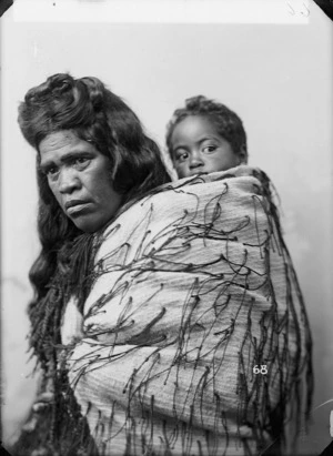Unidentified Maori woman with child and tag cloak