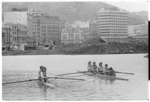 Boating club members, Wellington Harbour, with public works site on the shore behind