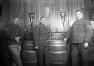 Unidentified World War 2 soldiers and beer barrels inside the canteen at Papakura Military Camp