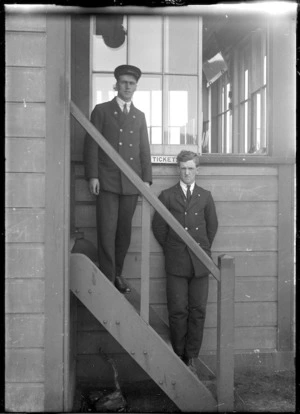 J McDonald and H Praytor, Silverstream railway staff, standing on the steps of the Silverstream Railway Station, circa 1921.