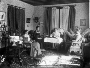 Members of the Simpson family having tea in a sitting room