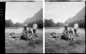 Unidentified people, resting, next to river bed, unidentified location