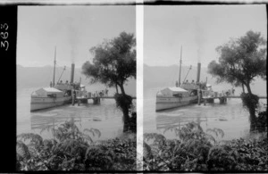 View of passenger boat Mountaineer, next to a short pier on a lake, unidentified location