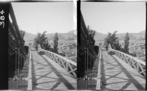 Motorcar on steel suspension bridge over river, [Queenstown-Lakes District?]