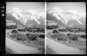 Road leading to The Hermitage Hotel, showing one side of hotel and glacier [on Mt Sefton?], Aoraki/Mt Cook National Park, Canterbury region