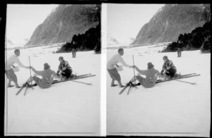 Unidentified female skiers, who have fallen down, including unidentified man [instructor or judge?] helping one up, Mount Cook National Park, Canterbury Region