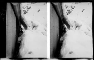 Heavy snow, outside a hut, descending from the roof, including unidentified man looking through a tunnel like gap, Mount Cook National Park, Canterbury Region