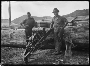 Two timber workers with a Wade saw (motorised crosscut saw), at Mangapehi, 1920.