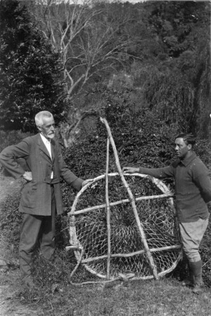 Elsdon Best and another man holding up a wooden framed fishing net