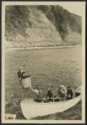 Woman being lowered into a longboat, Raoul Island