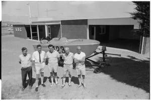 Senior members of the Kapiti Boating Club by rescue boat in front of new building