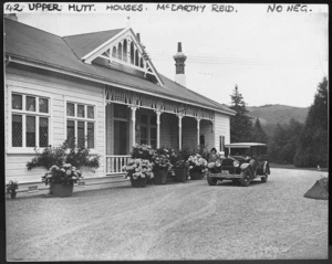 Mrs McCarthy Reid outside her house, at Totara Park, Upper Hutt, standing by her car before leaving for town