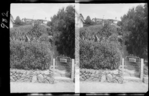 View of garden gate with 'Sefton' written on it, leading up a sloping garden path to a suburban house,[possibly Cashmere, Christchurch]
