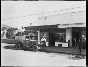 Delivery truck and butcher outside the butcher shop of G G Martin, Cuba Street, Petone, Lower Hutt