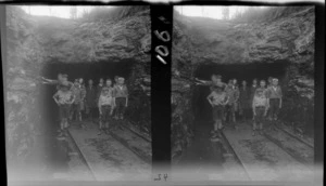 Group portrait of unidentified children and women at the entrance of a coal mine, West Coast, South Island