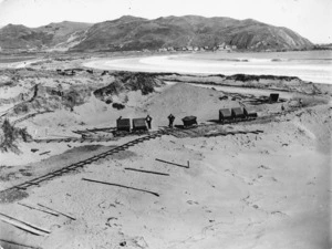 Sandhills alongside Lyall Bay, Wellington, with railway track and wagons