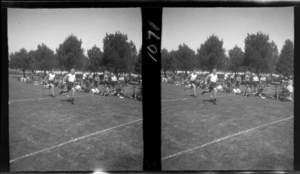 Community Sports Day, view of [Edgar Richard Williams?] and an unidentified man finishing a running race with a crowd looking on at an unknown field location