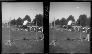 Community Sports Day, view of an unidentified man attempting the high-jump with a crowd looking on at an unknown field location