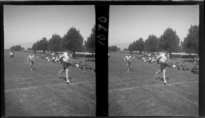 Community Sports Day, view of unidentified boys finishing a running race with a crowd looking on at an unknown field location