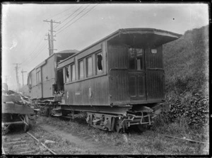 Exterior view of a wrecked railway carriage and guard's van after an accident.