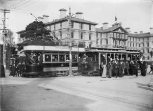 Trams and passengers, alongside Government Buildings, Lambton Quay, Wellington