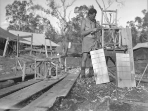 S P O'Conner of the 2nd NZEF IP making camp furniture at the works construction unit, New Caledonia