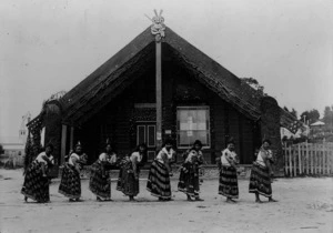 Maori women performing a traditional action song before Tamatekapua meeting house, Ohinemutu