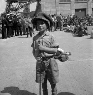 Young Maori boy, with soldiers cap, upon the return of the Maori Battalion, Wellington