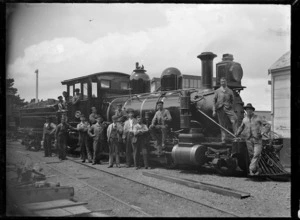 O Class steam locomotive NZR 54, 2-8-0 type, with a group of men on and beside the engine.