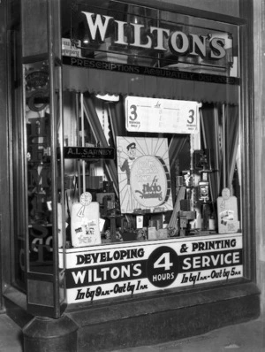 Window display in Wilton's chemist, Wanganui, advertising photographic developing and printing services