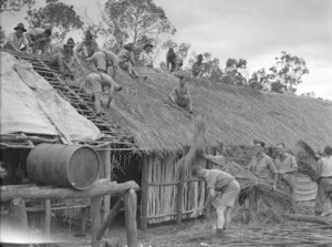 Soldiers of the 2nd NZEF IP thatching a newly built mess in New Caledonia
