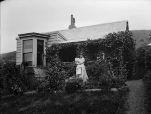 Lydia Williams holding her baby son Edgar, in the garden outside her house Viewbank on Maitland Street, Dunedin