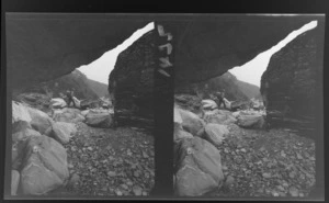 Unidentified tramper walking in rocky terrain, West Coast region