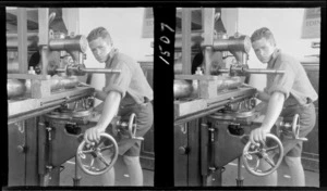 Unidentified student operating a machine in engineering workshop, location unknown