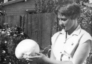 Girl holding giant puff-ball fungus (Clavatia gigantea)