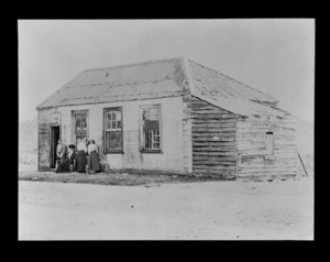 Unidentified women standing outside a house, unidentified location