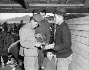 Korean repatriate's money being checked by Japanese customs official under New Zealand supervision at Senzaki