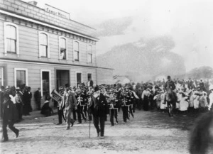 Scene by the Family Hotel in Otaki, with brass band and crowd