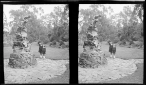 The Wonderland Peter Pan and Wendy like statue by sculptor Thomas Clapperton with two unidentified school girls in uniform, Oamaru Gardens, North Otago Region
