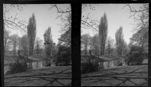 An unidentified man sitting by the Avon River opposite Hagley Park, Christchurch City