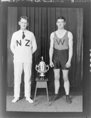 Boxer, Mr Thomas Arbuthnott, competitor in the 1936 Olympic Games, with trainer and trophy