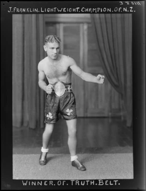 Mr Joe Franklin, lightweight boxing champion of New Zealand, wearing the 'Truth Belt'