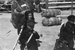 Korean women loaded with her possessions