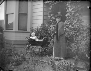 Lydia Williams, with her child Owen, in a pram outside their home, View Bank, Maitland Street, Dunedin