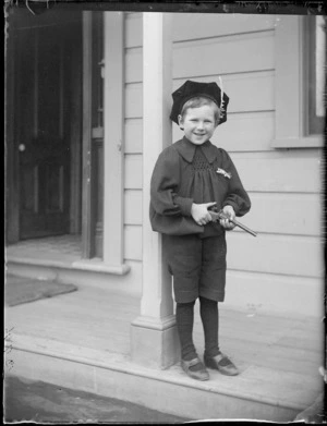 [Edgar Richard Williams?], standing on a porch, at his home, with a toy pistol, Royal Terrace, Kew, Dunedin