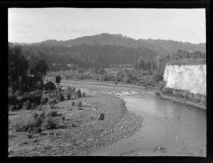 River scene, Kakahi, Manawatu-Whanganui, including cliff, trees and bush